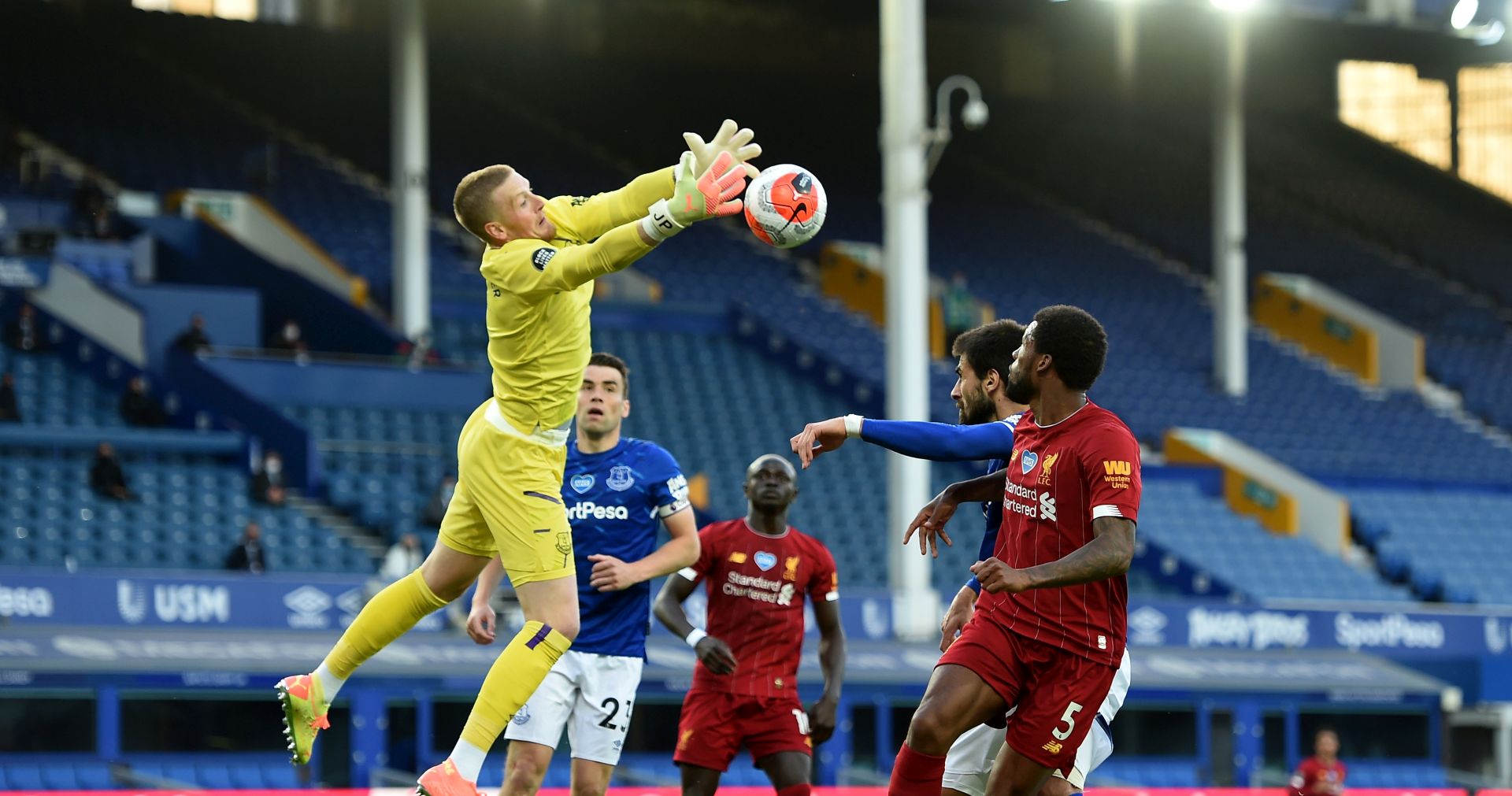 epa08501153 Everton's manager Peter Powell makes a save during the English Premier League soccer match between Everton FC and Liverpool FC in Liverpool, Britain, 21 June 2020.  EPA/PETER POWELL / NMC / EPA POOL EDITORIAL USE ONLY. No use with unauthorized audio, video, data, fixture lists, club/league logos or 'live' services. Online in-match use limited to 120 images, no video emulation. No use in betting, games or single club/league/player publications.