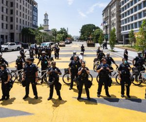 epa08504307 DC Police officers gather on 16th Street outside Lafayette Square the day after protestors attempted to remove a statue of President Andrew Jackson across from the White House in Washington, DC, USA, 23 June 2020. The death of George Floyd in Minneapolis police custody on 25 May 2020 sparked global protests demanding justice and racial equality.  EPA/JIM LO SCALZO