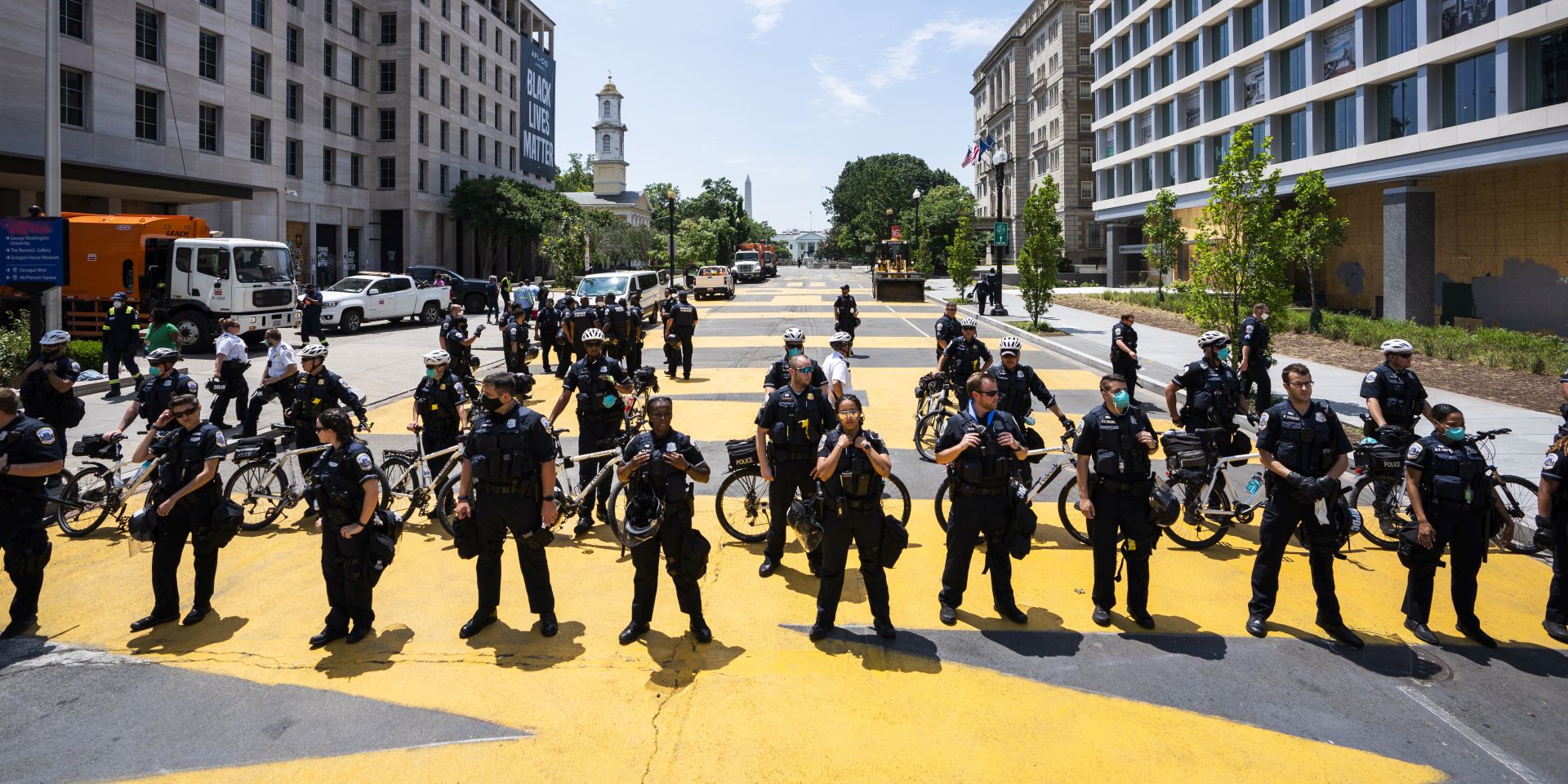 epa08504307 DC Police officers gather on 16th Street outside Lafayette Square the day after protestors attempted to remove a statue of President Andrew Jackson across from the White House in Washington, DC, USA, 23 June 2020. The death of George Floyd in Minneapolis police custody on 25 May 2020 sparked global protests demanding justice and racial equality.  EPA/JIM LO SCALZO