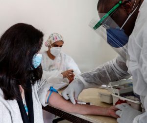 epa08518725 Professor Claubia Alexandra Brito, 46, undergoes a serological test in Sao Paulo, Brazil, 30 June 2020. The Municipality of Sao Paulo, the most populous city in South America and epicenter of the coronavirus pandemic in Brazil, carried out on Tuesday the second stage of a study to calculate how many people have already been infected by the pathogen in the city and thus design the best strategies to combat the virus. In the first stage of the seroprevalence investigation, carried out 15 days ago, the Municipal Health Secretariat detected that the São Paulo capital could have 1.16 million infected with the coronavirus, which represents 9.5% of its population and a figure ten times higher than the official number registered in the city, where some 12 million people live.  EPA/Sebastiao Moreira