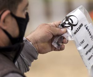 epa08521544 A man is given a self administered test for COVID-19 at a drive-in and walk up testing site at Lincoln Park amid the coronavirus pandemic in Los Angeles, California, 01 July 2020. California Governor Gavin Newsom announced on 01 July new measures as the number of people infected by the virus have recently spiked in California and in Los Angeles County.  EPA/ETIENNE LAURENT