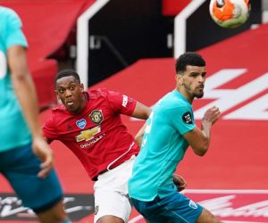 epa08526733 Anthony Martial (C) of Manchester United scores his team's third goal past Dominic Solanke of Bournemouth during the English Premier League match between Manchester United and AFC Bournemouth in Manchester, Britain, 04 July 2020.  EPA/Dave Thompson/NMC/Pool EDITORIAL USE ONLY. No use with unauthorized audio, video, data, fixture lists, club/league logos or 'live' services. Online in-match use limited to 120 images, no video emulation. No use in betting, games or single club/league/player publications.