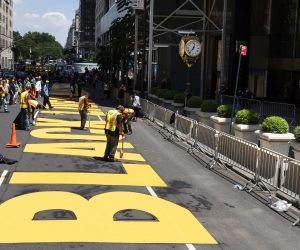epa08537121 Workers put the finishing touches on lettering reading 'Black Lives Matter' on Fifth Avenue in from of Trump Tower (R) in New York, New York, USA, 09 July 2020. New York City Mayor Bill de Blasio approved the public art project as a way to directly counter President Donald Trump’s dismissal of the Black Lives Matter movement.  EPA/JUSTIN LANE