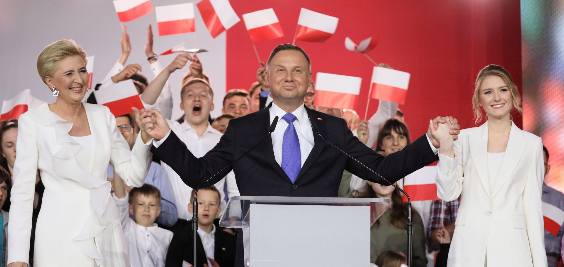 epa08542449 Incumbent President Andrzej Duda (C) with his wife Agata Kornhauser-Duda (L) and daughter Kinga Duda (R) gives statement after initial exit polls in Polish Presidential elections in Pultusk, Poland, 12 July 2020. According to initiall exit polls, Polish President Andrzej Duda has won percent 50.4 percent of votes and Civic Coalition candidate and Mayor of Warsaw Rafal Trzaskowski has won 49.6 percent of votes in the second round of presidential elections in Poland.  EPA/LESZEK SZYMANSKI POLAND OUT