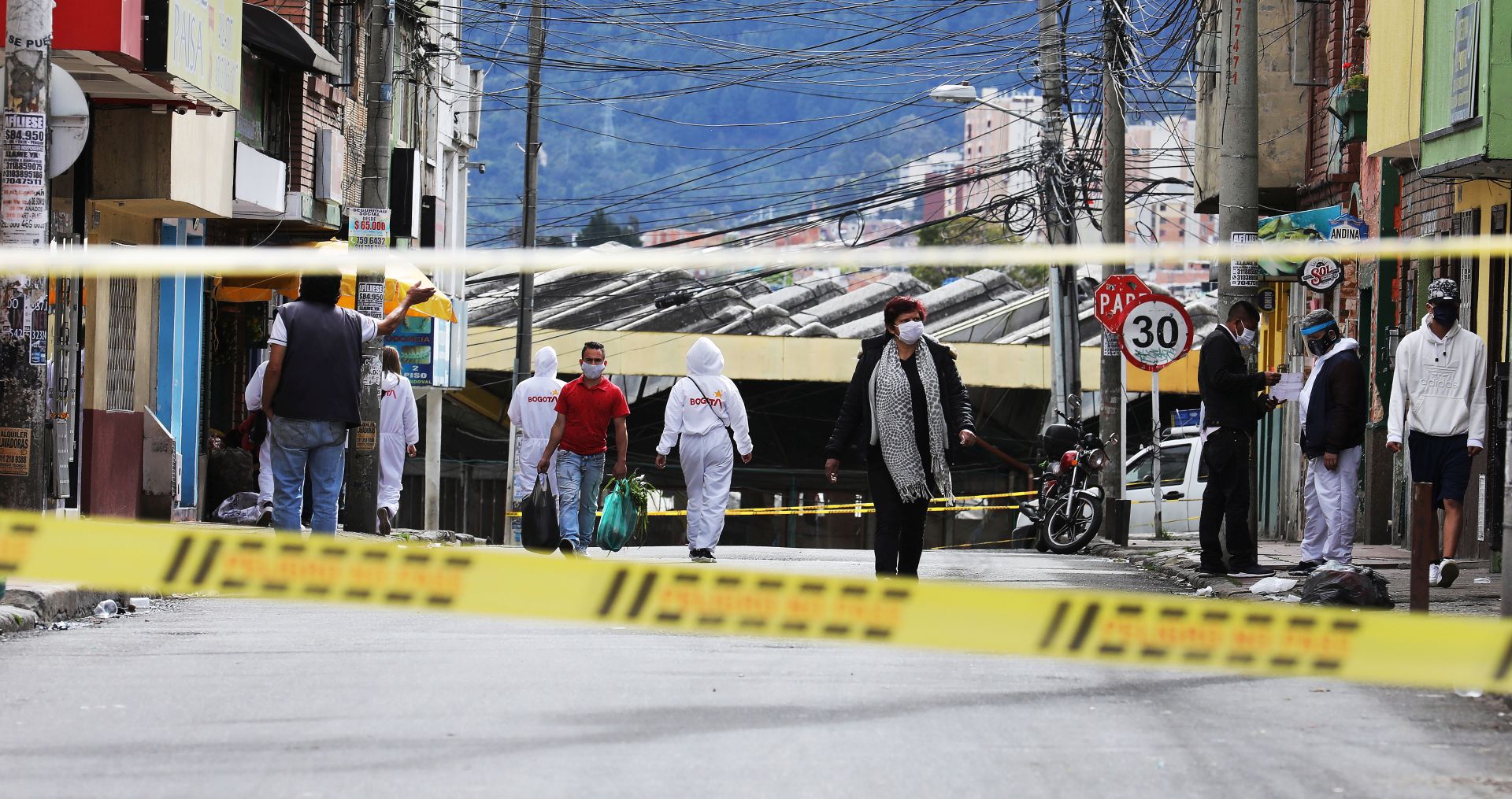 epa08544169 View of a tape to cordon off a street in the San Cristobal borough, one of the sectors that is on orange alert and strict quarantine due to the COVID-19 infections, in Bogota, Colombia, 13 July 2020. The Colombian capital, the main focus of COVID-19 in the country, returns this Monday to a strict but staggered quarantine in most of its neighborhoods to try to contain the pandemic, which infects more than two thousand people daily in the city.  EPA/Carlos Ortega