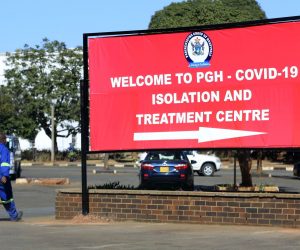 epa08547495 A man walks past a billboard pointing to a COVID-19 treatment centre at Parirenyatwa Hospital in Harare, Zimbabwe, 15 July 2020. President Emmerson Mnangagwa has said he will soon announce new lockdown measures to further curb the spread of the disease.  EPA/AARON UFUMELI