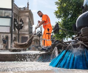 19 July 2020, Hessen, Frankfurt/Main: A member of the city cleaning service removes shards of broken glass from a bus stop in front of the Alte Oper. Nearly 40 people were arrested in the heart of Frankfurt after violent rioting broke out during a massive outdoor party near the German city's concert hall, police said on Sunday. Photo: Frank Rumpenhorst/dpa