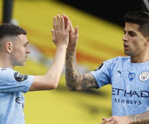 epa08559101 Phil Foden (L) of Manchester City celebrates with Joao Cancelo (R) of Manchester City  after scoring a goal during the English Premier League match between Watford and Manchester City in Watford, Britain, 21 July 2020.  EPA/John Sibley/NMC/Pool EDITORIAL USE ONLY. No use with unauthorized audio, video, data, fixture lists, club/league logos or 'live' services. Online in-match use limited to 120 images, no video emulation. No use in betting, games or single club/league/player publications.