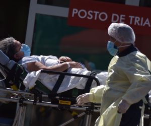 epa08563381 A woman is moved to an ambulance outside Asa Norte Hospital (Hospital Regional da Asa Norte-HRAN) in Brasilia, Brazil, 23 July 2020. Although authorities insist that the infection curve is stabilized in Brazil, the number of infections remains on the rise.  EPA/Andre Sousa Borges