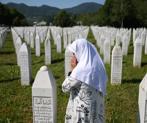 Bosnia and Herzegovina commemorates 25th anniversary of Srebrenica massacre, in Potocari A woman prays at a graveyard, ahead of a mass funeral in Potocari near Srebrenica, Bosnia and Herzegovina July 11, 2020. Bosnia marks the 25th anniversary of the massacre of more than 8,000 Bosnian Muslim men and boys, with many relatives unable to attend due to the coronavirus disease (COVID-19) outbreak. REUTERS/Dado Ruvic DADO RUVIC