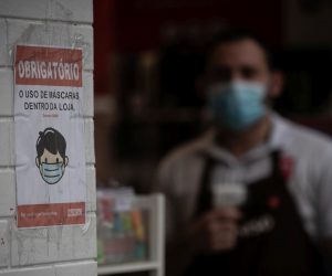 epa08550226 Detail of the sign with an indication of mandatory use of face masks inside a store, in Sao Paulo, Brazil, 16 July 2020.  EPA/Fernando Bizerra