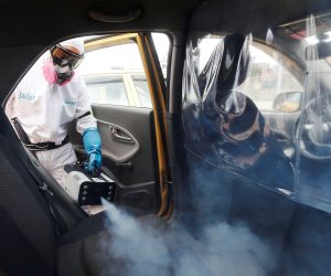 epaselect epa08573514 A worker disinfects the interior of a taxi in Bogota, Colombia, 29 July 2020. Colombia is the new focus of the pandemic in Latin America, with a high rate of infections that has already reached 10,000 daily, a situation that led the Government to extend the quarantine for another month, a measure received with skepticism by experts given the numerous exceptions in force. The country, which accumulates more than 267,000 infections, completes a month with daily figures of more than 7,000 cases, statistics focused mainly on Bogotá and Medellin.  EPA/Carlos Ortega
