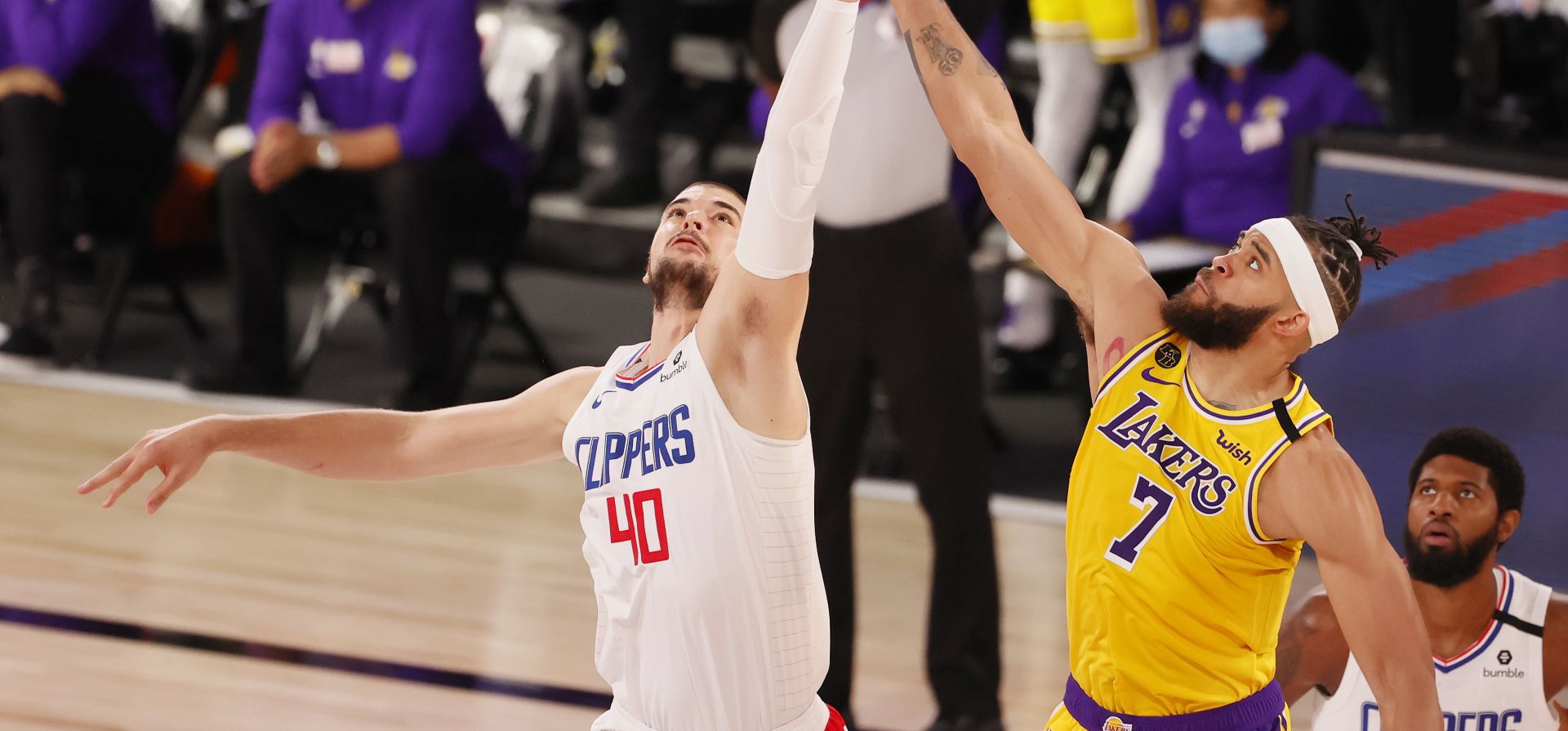 epa08575666 Los Angeles Clippers Ivica Zubac (L) and Los Angeles Lakers JaVale McGee (R) at the opening tip-off during their game at the ESPN Wide World of Sports complex restarting the NBA season in Kissimmee, Florida, USA, 30 July 2020. The NBA season is resuming with 22 teams playing all games at the Walt Disney World sports complex outside Orlando, Florida.  EPA/ERIK S. LESSER SHUTTERSTOCK OUT