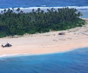epa08582829 A handout photo made available by the Australian Department of Defence shows an Australian Army ARH-90 Tiger Helicopter landing on Pikelot Island in the Federated States of Micronesia, 02 August 2020 (issued 04 August 2020), where three men were found safe and healthy after missing for three days. Their SOS message outlined on a beach was spotted from the air by Australian and US aircraft searching the area.  EPA/AUSTRALIAN DEFENCE FORCE HANDOUT -- MANDATORY CREDIT: COMMONWEALTH OF AUSTRALIA 2020 -- HANDOUT EDITORIAL USE ONLY/NO SALES *** Local Caption *** HMAS Canberra and its embarked aviation assets have assisted in locating the three-person crew of a skiff that had been missing for nearly three days in waters off the Federated States of Micronesia. The men were found on 2 August in good condition on Pikelot Island, 190 kilometres west of where they had set off in their 23-foot (seven-metre) skiff on 30 July. Their SOS message outlined on a beach was spotted from the air by Australian and US aircraft searching the area. 

The Australian Defence Force had been asked for search and rescue support by the Rescue and Coordination Centre (RCC) in Guam on the afternoon of 1 August 2020. 

A US Air Force KC-135 aircraft located a rudimentary SOS sign on the beach, which queued HMAS Canberra and her embarked helicopters to locate the missing sailors. A US Coast Guard C-130 aircraft also assisted in the search, providing supplies and communications through an air drop.