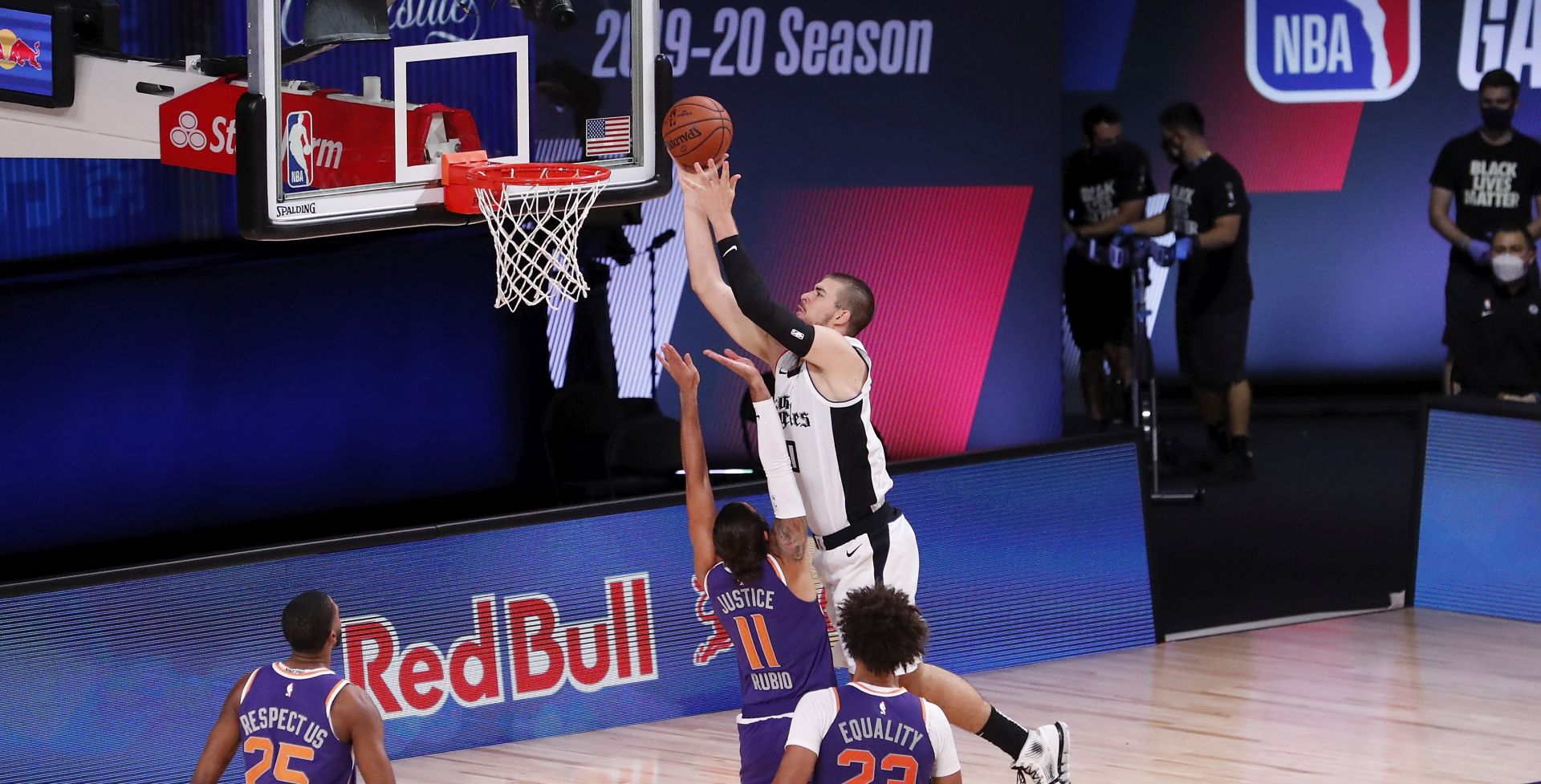 epa08584256 LA Clippers center Ivica Zubac (R) shoots over defending Phoenix Suns guard Ricky Rubio (L) during the third quarter of the NBA basketball game between the Phoenix Suns  and the LA Clippers  at the ESPN Wide World of Sports Complex in Kissimmee, Florida, USA, 04 August 2020. The NBA season has restarted at the Walt Disney World sports complex outside Orlando, Florida.  EPA/ERIK S. LESSER SHUTTERSTOCK OUT