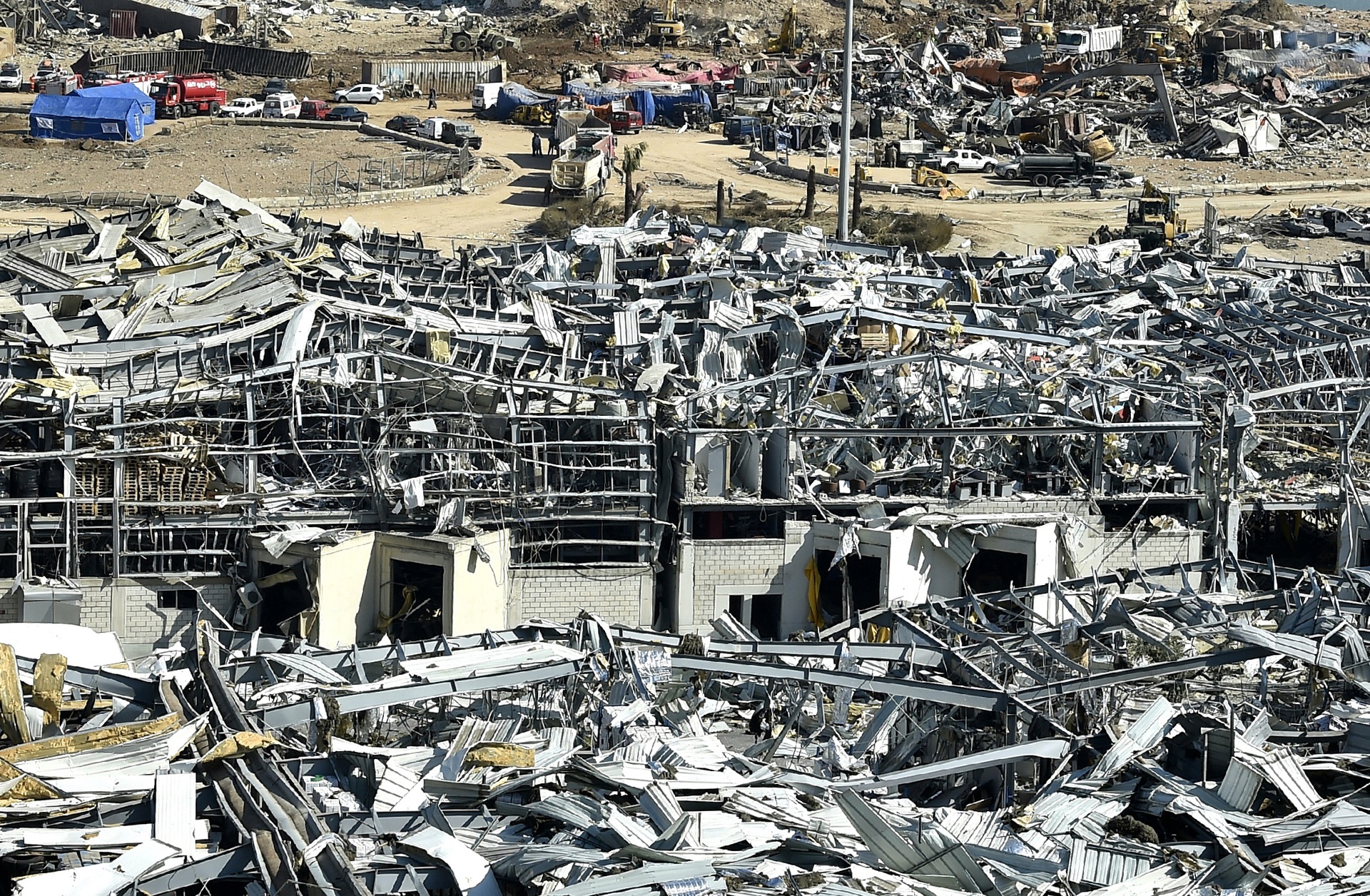 epa08586862 A general view of the destroyed port in the aftermath of a massive explosion as search and rescue works for victims continued, in downtown Beirut, Lebanon, 06 August 2020. According to the Lebanese Health Ministry, at least 135 people were killed, and more than 5,000 injured in the blast believed to have been caused by an estimated 2,750 of ammonium nitrate stored in a warehouse. The explosion on 04 August 2020 devastated the port area and parts of the city.  EPA/WAEL HAMZEH