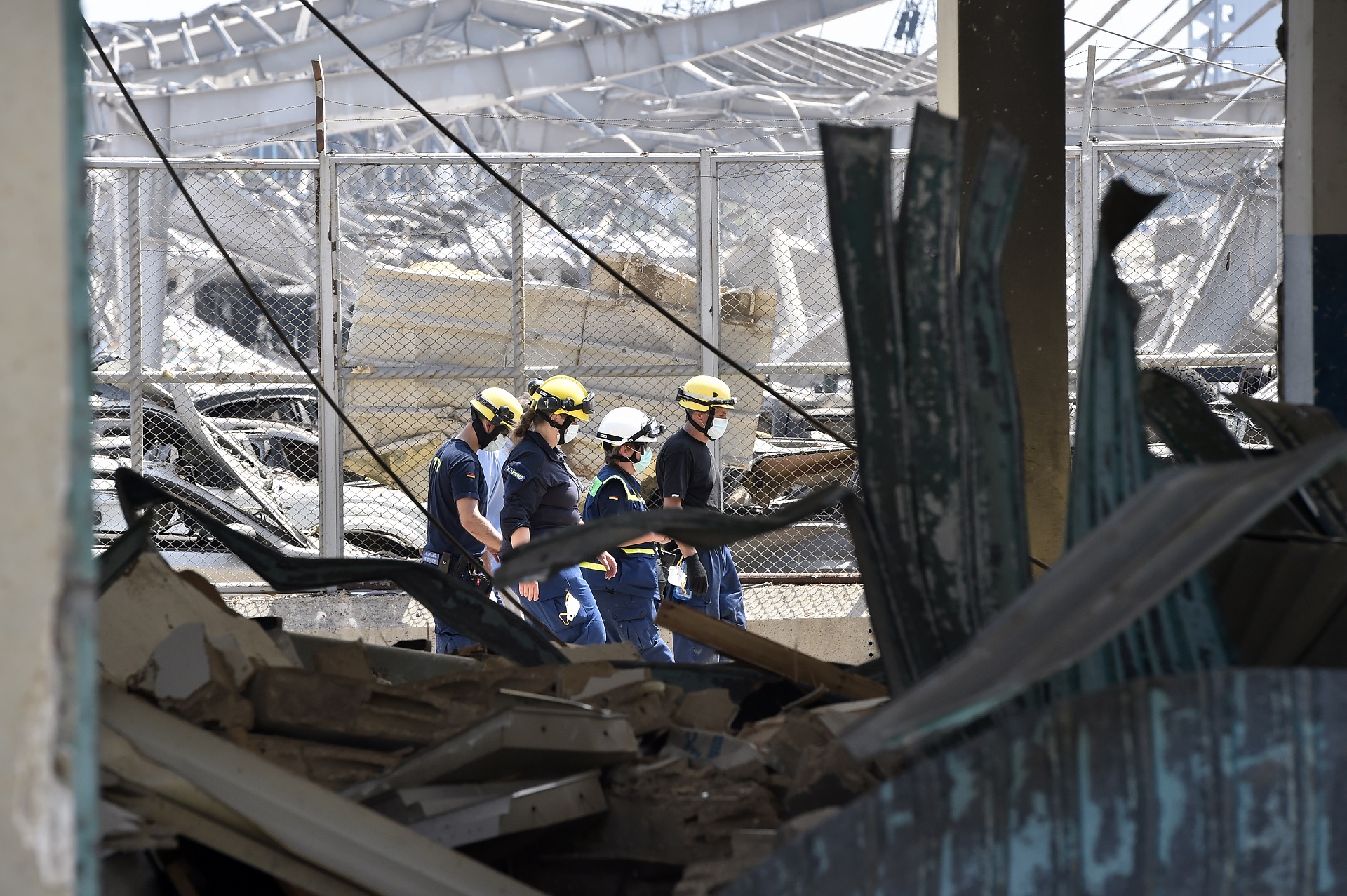 epa08589337 Members of German Federal Agency for Technical Relief (THW) search for bodies and survivors amid the rubble three days after explosions that hit Beirut port, in Beirut, Lebanon, 07 August 2020. According to the Lebanese Health Ministry, at least 137 people were killed, and more than 5,000 injured in the blast believed to have been caused by an estimated 2,750 tons of ammonium nitrate stored in a warehouse. The explosion and its shockwave on 04 August 2020 devastated the port area.  EPA/WAEL HAMZEH