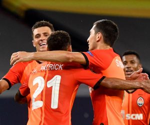 11 August 2020, North Rhine-Westphalia, Gelsenkirchen: Shakhtar Donetsk's Alan Patrick (C) celebrates scoring his side's third goal with his team mates Junior Moraes (L) and Taras Stepanenko during the UEFA Europa League quarter-final soccer match between FC Shakhtar Donetsk and FC Basel at the Veltins-Arena. Photo: Bernd Thissen/dpa