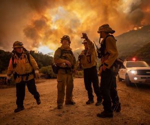 epaselect epa08600280 Firefighters make an escape plan as the Lake Fire burns a hillside in Lake Hughes, California, USA, 12 August 2020.  EPA/CHRISTIAN MONTERROSA