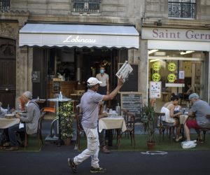 epa08600443 French Pakistani Ali Akbar sells newspapers in a street of Saint Germain des Pres district in Paris, France, 07 August 2020 (issued 13 August 2020). Ali Akbar, 67, born near Islamabad in Pakistan, arrived illegally in France in 1973 and became a newspapers seller in Saint Germain des Pres. He met famous journalists, writers and politics of the district. After 40 years of work in the streets, Ali Akbar, the last newspaper seller in Paris, retires.  EPA/Julien de Rosa ATTENTION: This Image is part of a PHOTO SET