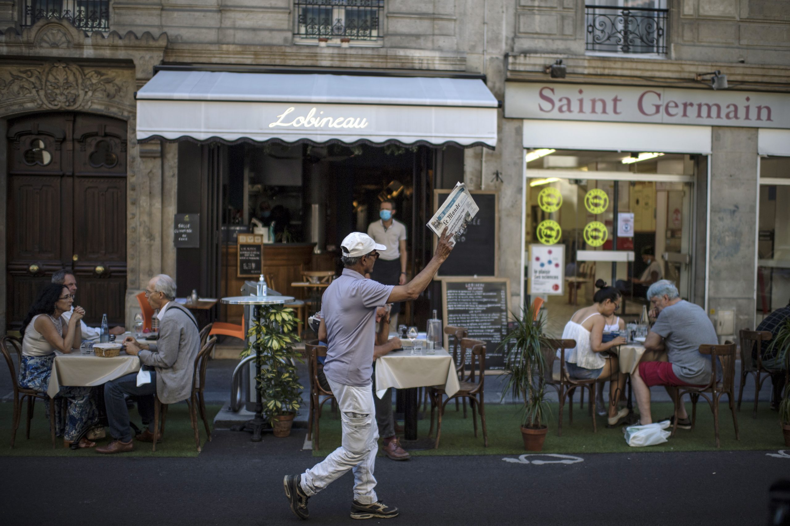 epa08600443 French Pakistani Ali Akbar sells newspapers in a street of Saint Germain des Pres district in Paris, France, 07 August 2020 (issued 13 August 2020). Ali Akbar, 67, born near Islamabad in Pakistan, arrived illegally in France in 1973 and became a newspapers seller in Saint Germain des Pres. He met famous journalists, writers and politics of the district. After 40 years of work in the streets, Ali Akbar, the last newspaper seller in Paris, retires.  EPA/Julien de Rosa ATTENTION: This Image is part of a PHOTO SET