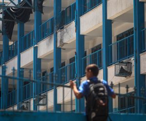 epa08600737 A Palestinian student takes a look at the damage done to his UNRWA school after it was hit by an Israeli drone in Al-Shati refugee camp, western Gaza city, 13 August 2020. An educational institution run by United Nations Relief and Works Agency (UNRWA) was hit by an Israeli drone as Israeli warplanes were targeting several locations of Hamas in Gaza city, according to reports.  EPA/MOHAMMED SABER