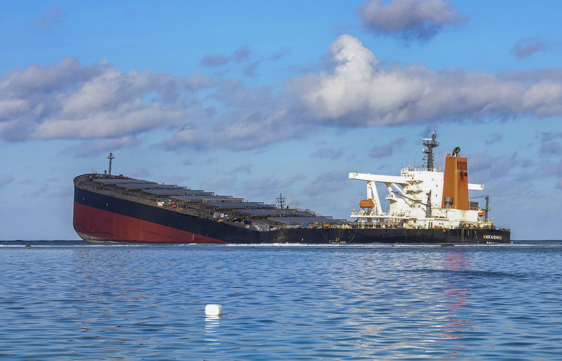 epa08602642 A general view of the MV Wakashio, a Japanese owned Panama-flagged bulk carrier after it ran aground off the southeast coast of Mauritius, 13 August 2020 (issued 14 August 2020). The ship was sailing from China to Brazil when it hit coral reefs near Pointe d'Esny on 25 July 2020. Oil from the grounded ship is damaging protected marine ecosystems. According to Prime Minister Pravind Jugnauth, who declared a state of environmental emergency, most of the oil has been removed from the ship. However, there are fears the ship could break up spilling more oil into the ocean. Containment booms have been set up in multiple locations nearby to try and contain the oil slick.  EPA/STRINGER