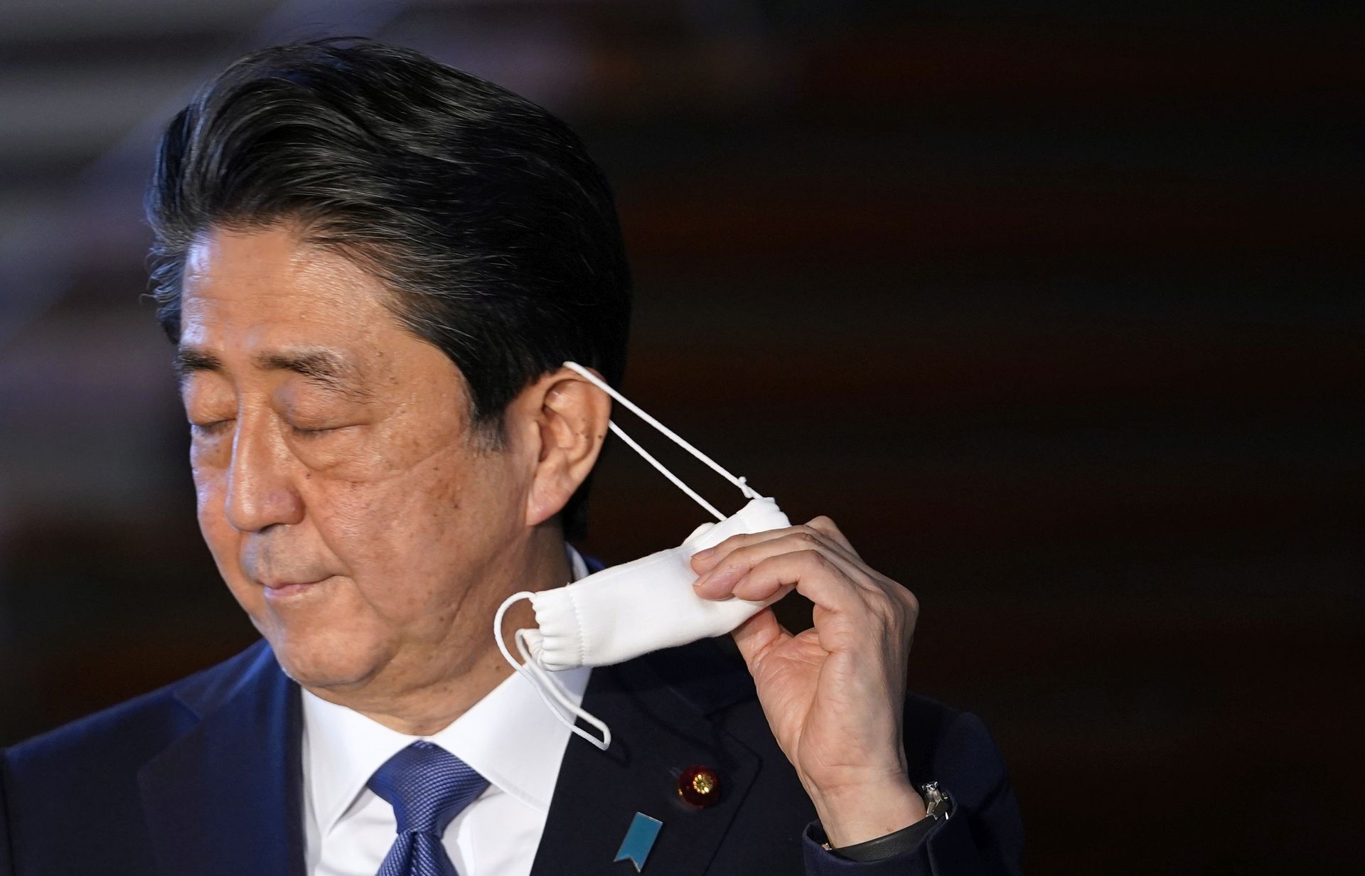 epa08608398 (FILE) - Japanese Prime Minister Shinzo Abe takes off his face mask as he arrives at a press conference at the prime minister's official residence in Tokyo, Japan, 06 April 2020 (reissued 17 August 2020). According to Japanese government sources, Abe, who entered a hospital in Tokyo for a medical check-up on 17 August, plans to return home later in the day. A top government official was reportedly concerned that Abe was suffering from fatigue due to the workload amid the ongoing coronavirus pandemic crisis.  EPA/FRANCK ROBICHON