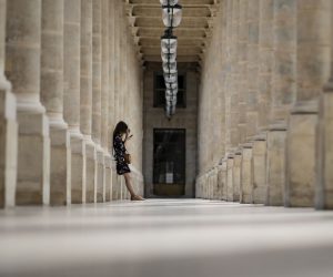 epa08614392 A woman pauses in an arcade of the Palais Royal in Paris, France, 20 August 2020. Paris has been declared a zone of 'active circulation' for the Covid19 coronavirus as cases surged in recent weeks, prompting British tourists vacationing in France to be recalled back to their homeland or face fourteen days quarantine upon arrival. The spike in Covid cases and foreign tourist exodus is affecting Paris' tourism industry, with media reports of hotel reservations down by 86 per cent comparatively to last year.  EPA/IAN LANGSDON