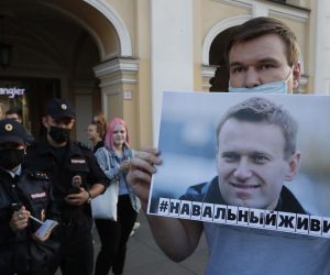 epa08615108 A man holds a poster with sign that reads 'Navalny let's live' during single picket to supporting Alexey Navalny in St. Petersburg, Russia, 20 August 2020. Russian opposition activist Alexei Navalny was placed in the hospital after he felt bad on board of a plane on his way from Tomsk to Moscow. The flight was interrupted and after landing in Omsk, Navalny was admitted to the hospital with the suspicion of a toxic poisoning.  EPA/ANATOLY MALTSEV