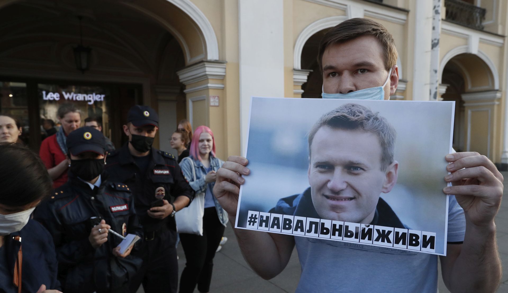 epa08615108 A man holds a poster with sign that reads 'Navalny let's live' during single picket to supporting Alexey Navalny in St. Petersburg, Russia, 20 August 2020. Russian opposition activist Alexei Navalny was placed in the hospital after he felt bad on board of a plane on his way from Tomsk to Moscow. The flight was interrupted and after landing in Omsk, Navalny was admitted to the hospital with the suspicion of a toxic poisoning.  EPA/ANATOLY MALTSEV
