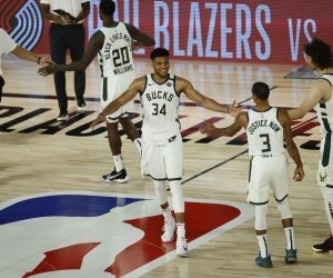 epa08615674 Milwaukee Bucks forward Giannis Antetokounmpo (C) greets his teammates after defeating the Orlando Magic during the second half of the NBA basketball first-round playoff game two between the Orlando Magic and Milwaukee Bucks at the ESPN Wide World of Sports Complex in Kissimmee, Florida, USA, 20 August 2020.  EPA/JOHN G. MABANGLO SHUTTERSTOCK OUT