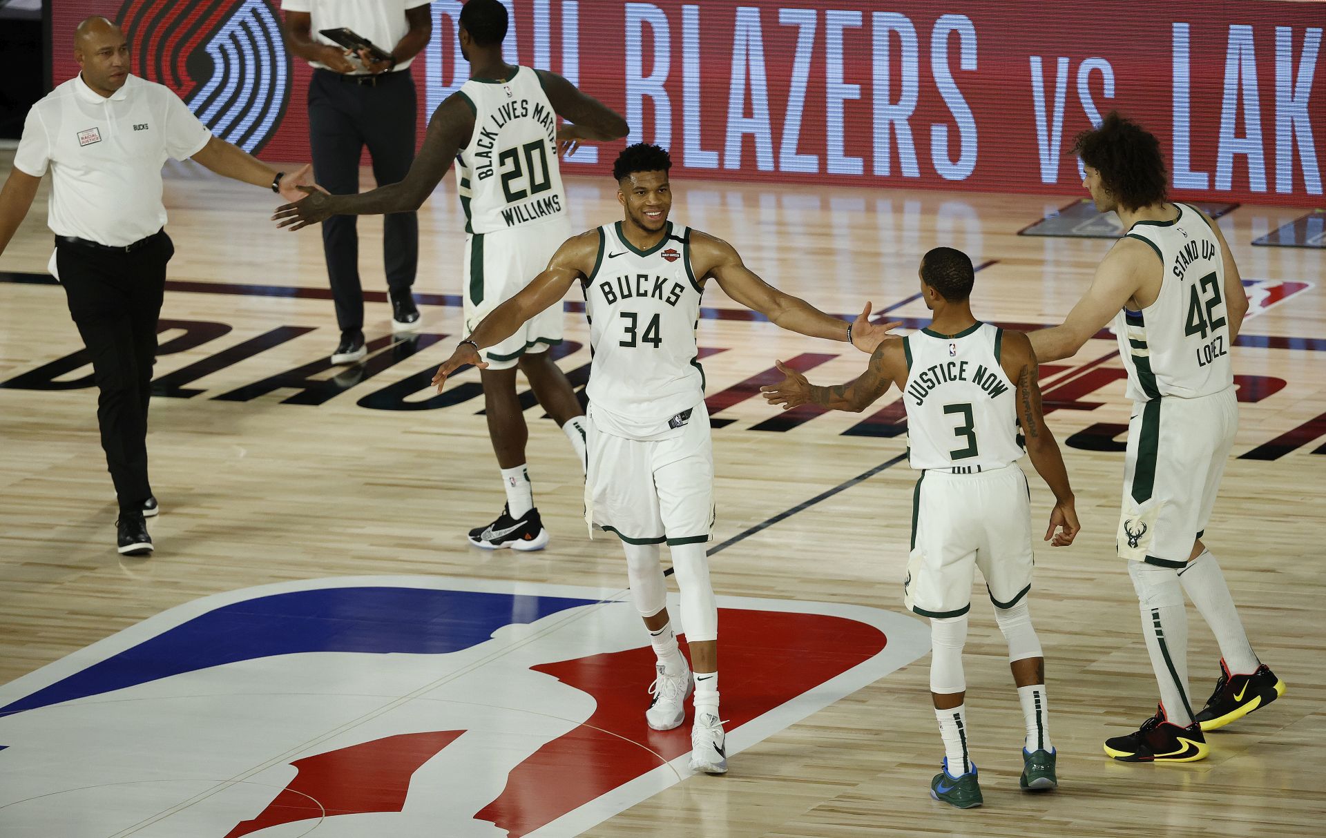 epa08615674 Milwaukee Bucks forward Giannis Antetokounmpo (C) greets his teammates after defeating the Orlando Magic during the second half of the NBA basketball first-round playoff game two between the Orlando Magic and Milwaukee Bucks at the ESPN Wide World of Sports Complex in Kissimmee, Florida, USA, 20 August 2020.  EPA/JOHN G. MABANGLO SHUTTERSTOCK OUT