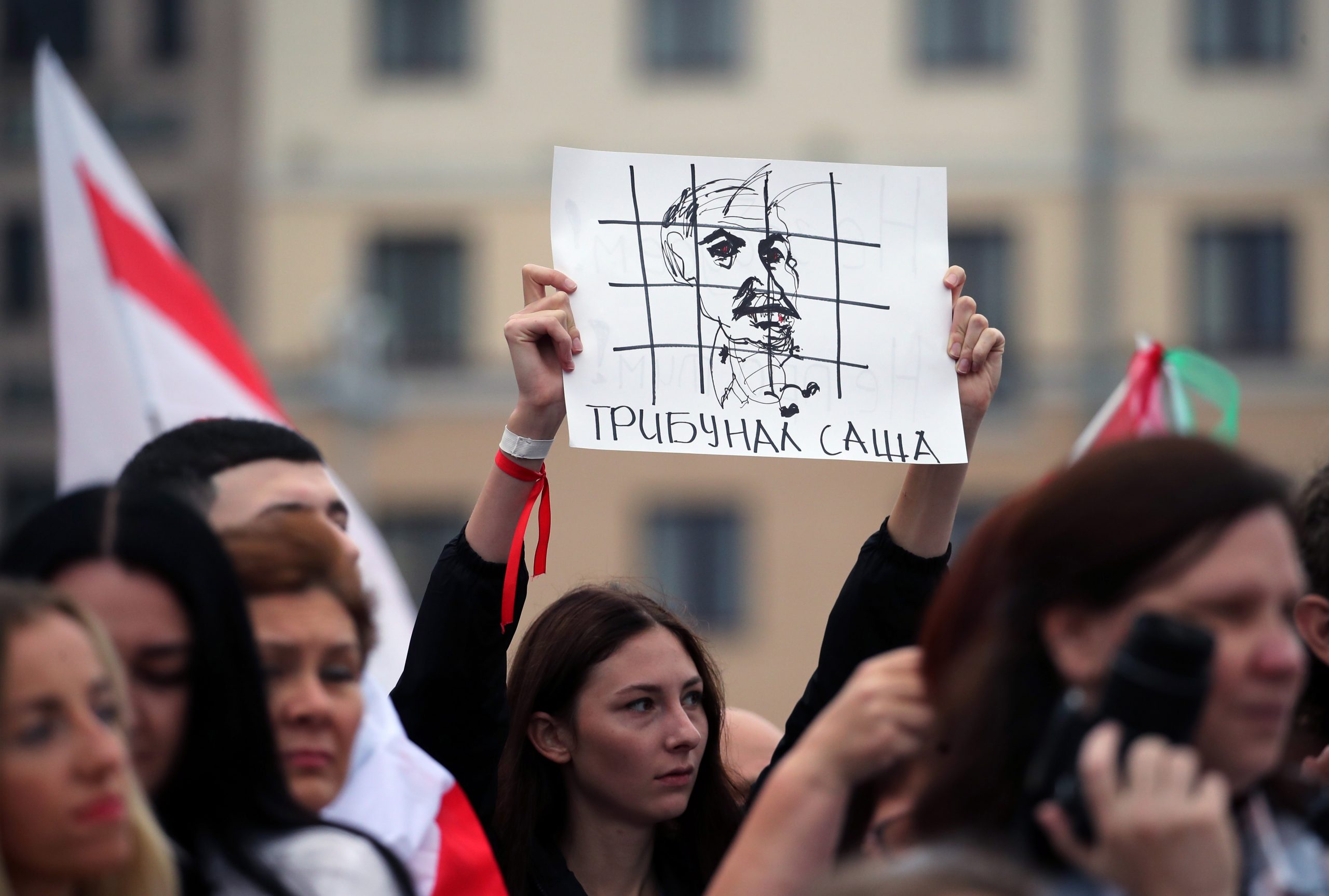 epa08619646 Opposition activists shout slogans and hold placard showing a drawing of Lukashenko in a prison cage, during a protest march against the results of the presidential elections, in Minsk, Belarus 23 August 2020. Opposition in Belarus alleges poll-rigging and police violence at protests following election results claiming that president Lukashenko had won a landslide victory in the 09 August elections.  EPA/TATYANA ZENKOVICH