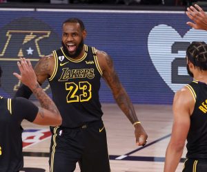 epa08623552 Los Angeles Lakers forward LeBron James (C) is greeted by Los Angeles Lakers forward Anthony Davis (L) and Los Angeles Lakers center JaVale McGee (R) after shooting a three point shot against the Portland Trail Blazers during the first half of the NBA basketball first-round playoff game four at the ESPN Wide World of Sports Complex in Kissimmee, Florida, USA, 24 August 2020.  EPA/JOHN G. MABANGLO  SHUTTERSTOCK OUT