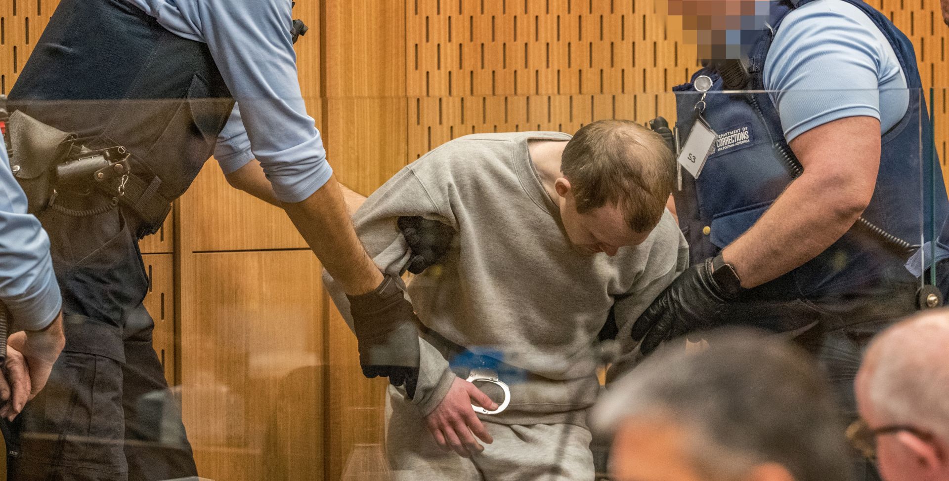 epa08626151 Guards handle Brenton Tarrant (C) during day three sentencing at the High Court in Christchurch, New Zealand, 26 August 2020. Australian white supremacist Brenton Tarrant will be sentenced for terrorism, 51 murders and 40 attempted murders, for his attack on two mosques in Christchurch in 2019.  EPA/JOHN KIRK-ANDERSON / POOL AUSTRALIA AND NEW ZEALAND OUT  
IMAGE PIXELATED AT SOURCE