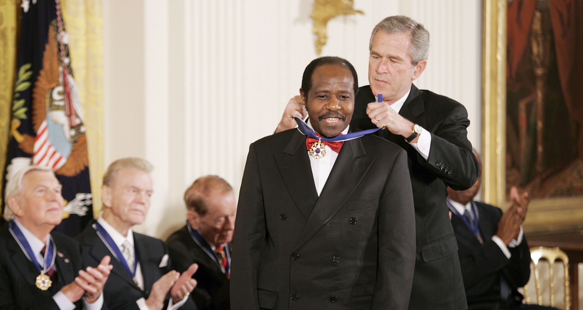 epa08637332 (FILE) - US President George W. Bush awards the Presidential Medal of Freedom to Rwandan hotelier Paul Rusesabagina, who protected people at a hotel he managed during the 1994 Rwandan genocide, during a ceremony in the East Room of the White House in Washington, DC, USA, 09 November 2005 (reissued 31 August 2020). Rwandan authorities on 31 August 2020 said that Rusesabagina was arrested on terror related offenses in Kigali.  The Rwanda Investigation Buerau (RIB) in a statement announced he was "subject of an International Arrest Warrant, wanted to answer charges of serious crime including terrorism, arson, kidnap and murder".  EPA/SHAWN THEW *** Local Caption *** 00571061