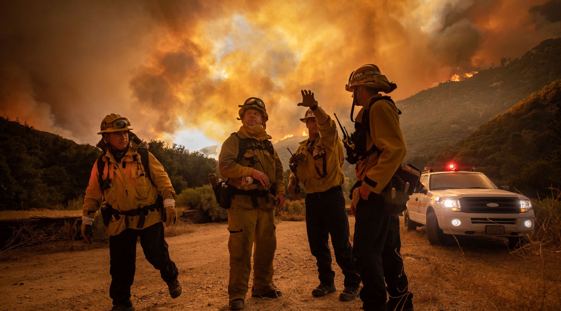 epaselect epa08600280 Firefighters make an escape plan as the Lake Fire burns a hillside in Lake Hughes, California, USA, 12 August 2020.  EPA/CHRISTIAN MONTERROSA