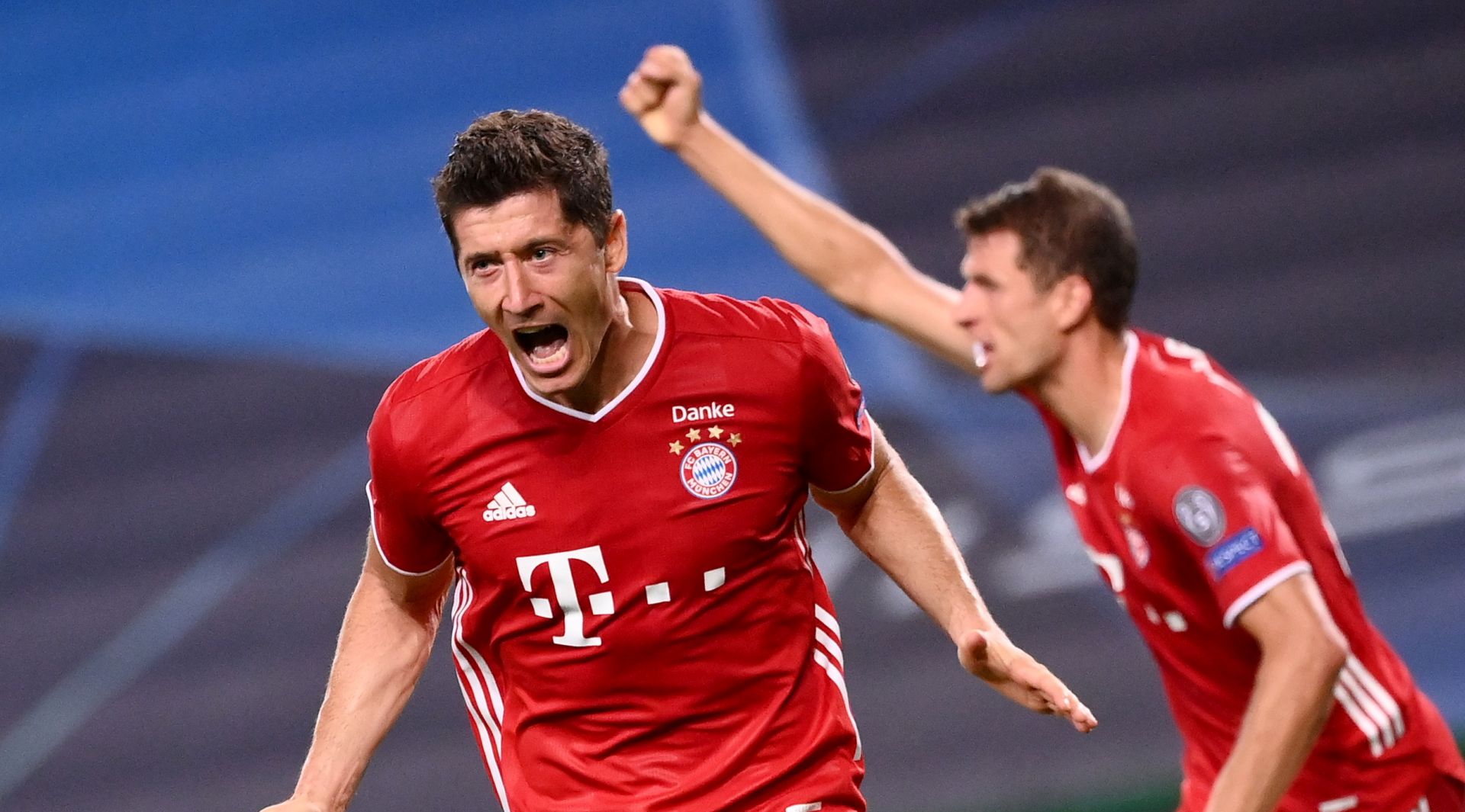epa08613554 Robert Lewandowski (L) of Bayern Munich  celebrates scoring the 3-0 lead during the UEFA Champions League semi final match between Olympique Lyon and Bayern Munich in Lisbon, Portugal, 19 August 2020.  EPA/Franck Fife / POOL