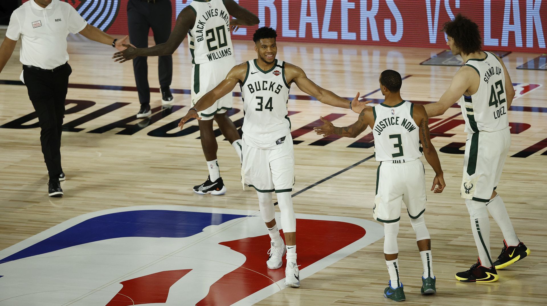 epa08615674 Milwaukee Bucks forward Giannis Antetokounmpo (C) greets his teammates after defeating the Orlando Magic during the second half of the NBA basketball first-round playoff game two between the Orlando Magic and Milwaukee Bucks at the ESPN Wide World of Sports Complex in Kissimmee, Florida, USA, 20 August 2020.  EPA/JOHN G. MABANGLO SHUTTERSTOCK OUT