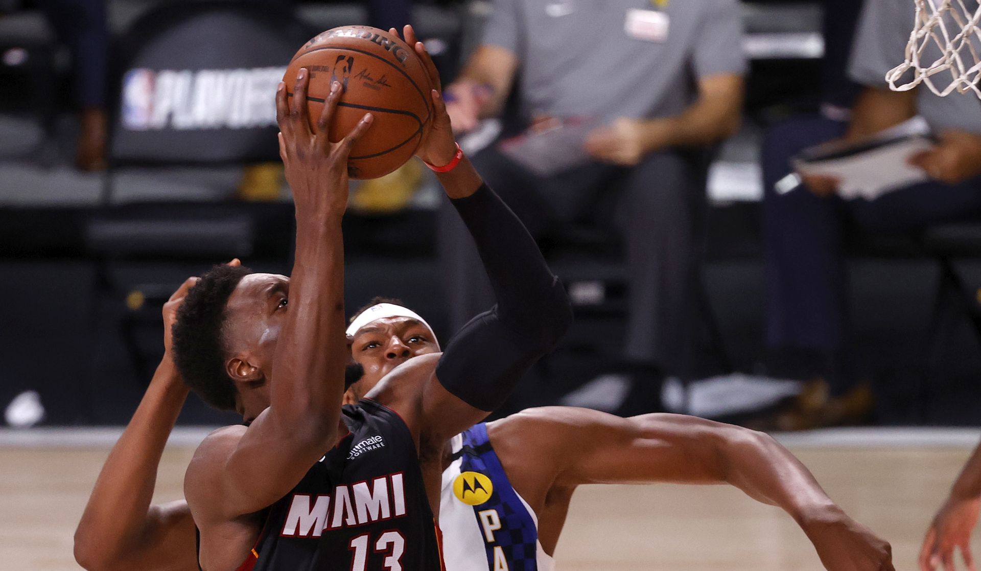 epa08619168 Miami Heat forward Bam Adebayo (L) goes to the basket as Indiana Pacers center Myles Turner (R) defends during the first half of the NBA basketball first-round playoff game three at the ESPN Wide World of Sports Complex in Kissimmee, Florida, USA, 22 August 2020.  EPA/JOHN G. MABANGLO SHUTTERSTOCK OUT