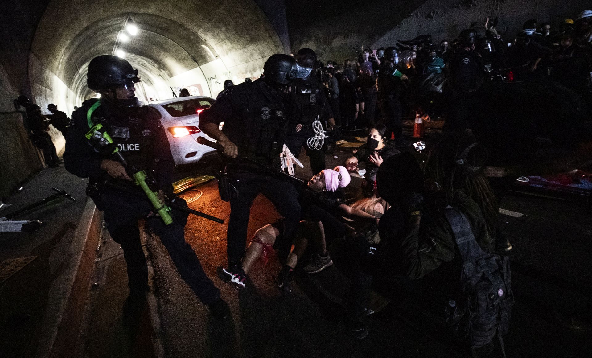 epa08628459 Los Angeles police officers charge protesters and shoot non-lethal ammunition during a protest in Los Angeles, California, USA, 26 August 2020. The protest was in held in response to the police shooting of Jacob Blake in Wisconsin and Anthony McClain in Pasadena.  EPA/ETIENNE LAURENT