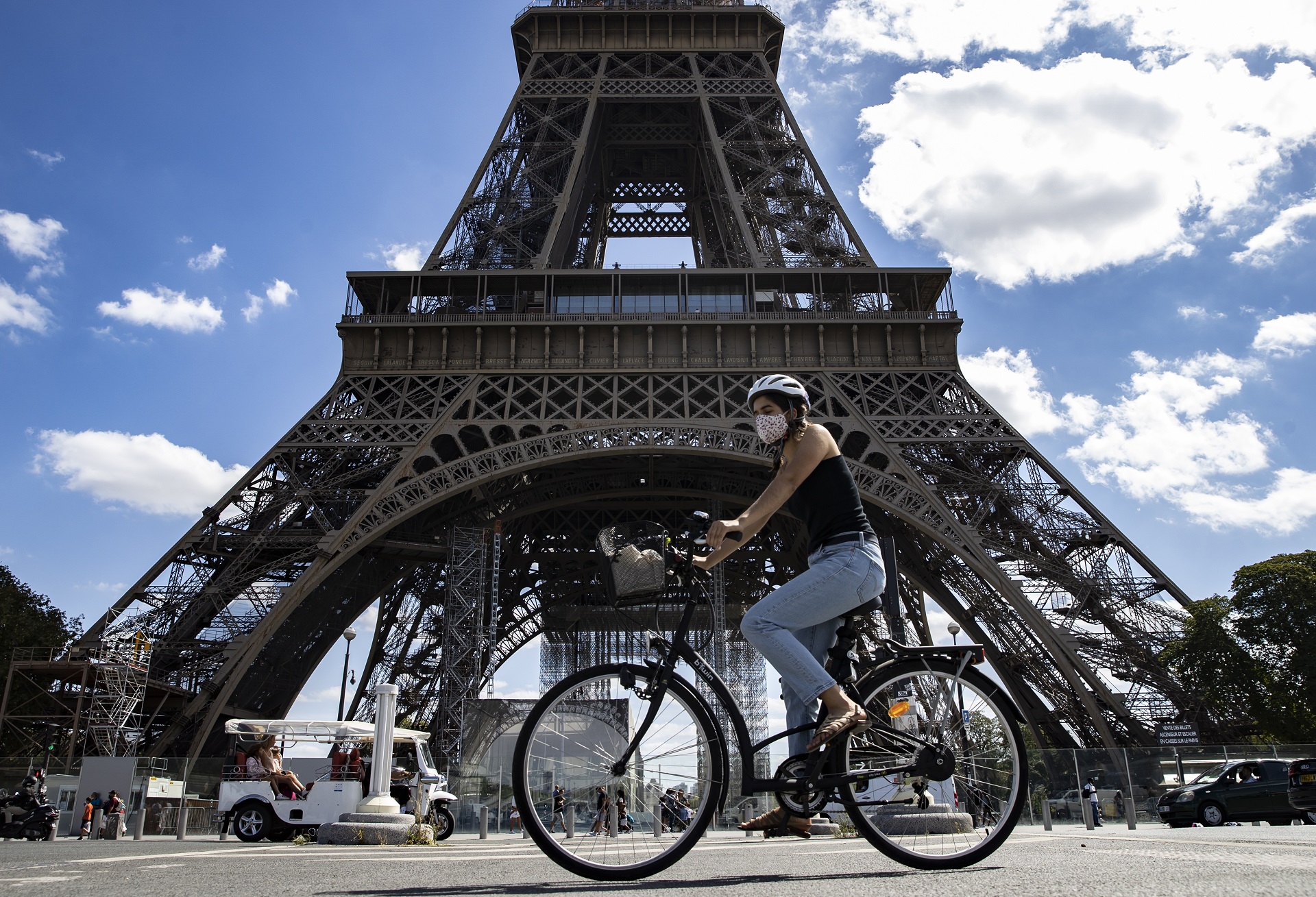 epa08629169 A woman wearing a protective face mask rides her bicycle near the Eiffel Tower, in Paris, France, 27 August 2020. French Prime Minister Jean Castex has announced that measures are being taken to enforce mask-wearing across the entire city of Paris, which has been declared a zone of 'active circulation' for the coronavirus SARS-CoV-2 which causes the Covid-19 disease. Cases in France have surged in recent weeks, with over 5000 new cases recorded in a 24 hour period.  EPA/IAN LANGSDON
