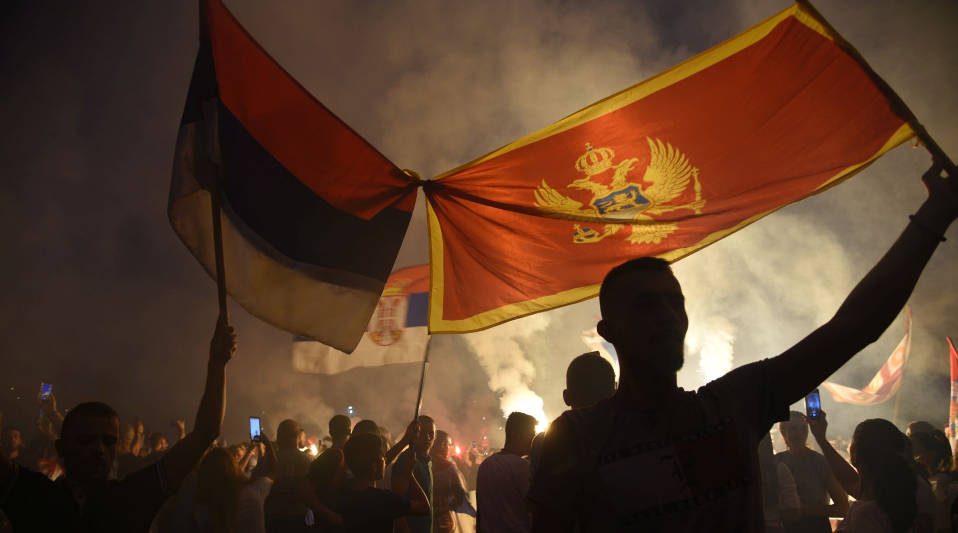 epa08637994 Montenegrian opposition supporters celebrate the election results in Podgorica, Montenegro, 31 August 2020. Montenegian opposition groups claimed victory against the Milo Djukanovic's ruling party in a tense parliamentary election that could possibly see a change in the course of the small Balkan state.  EPA/BORIS PEJOVIC