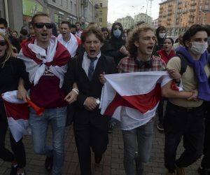 epa08639798 Belarusian students wave the opposition flag to show their solidarity with political detainees, prisoners, beaten opposition activists during a protest against official results of the presidential election in Minsk, Belarus, 01 September 2020. Belarusian students started the new school year from the mass protests.  EPA/STRINGER