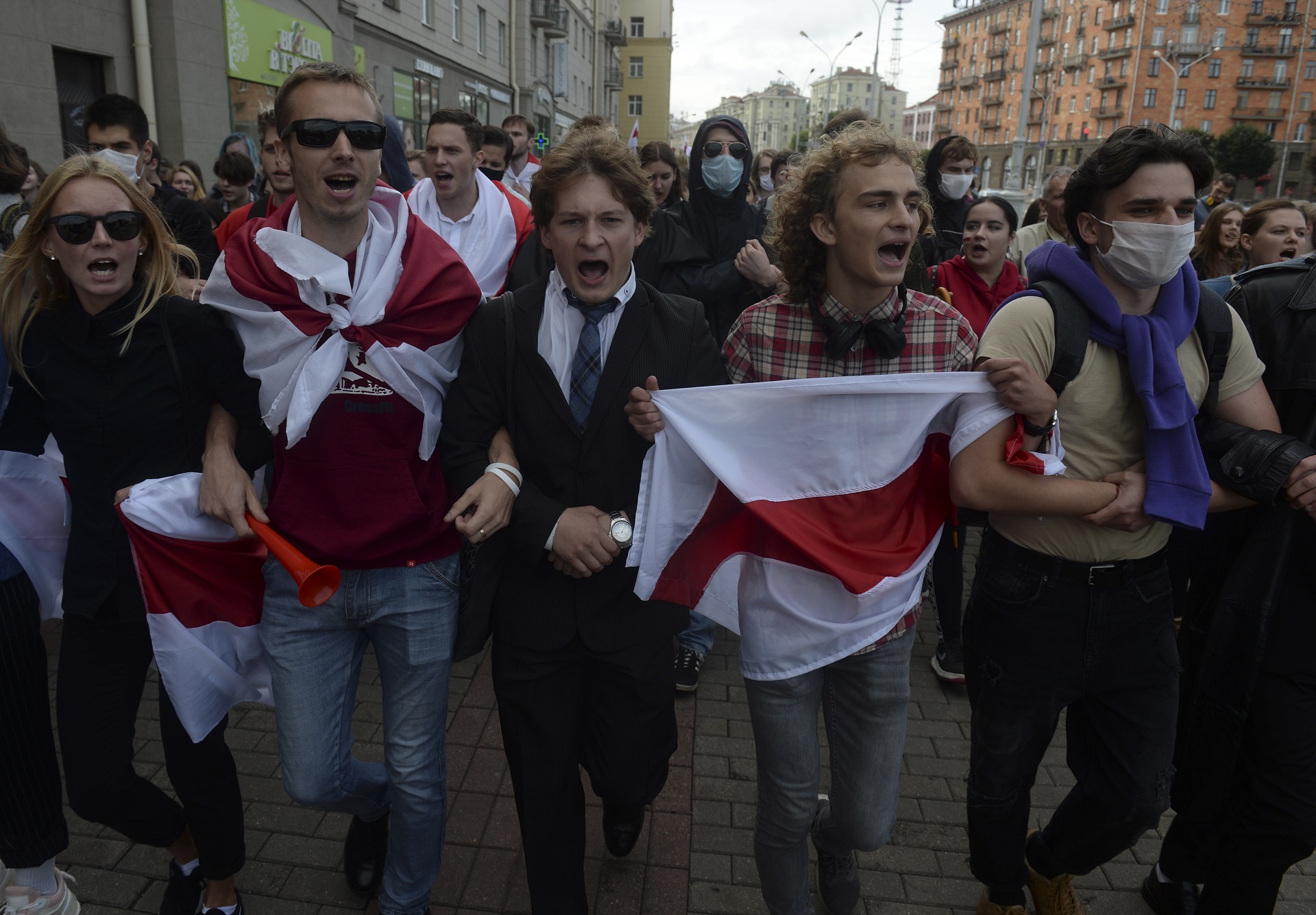 epa08639798 Belarusian students wave the opposition flag to show their solidarity with political detainees, prisoners, beaten opposition activists during a protest against official results of the presidential election in Minsk, Belarus, 01 September 2020. Belarusian students started the new school year from the mass protests.  EPA/STRINGER