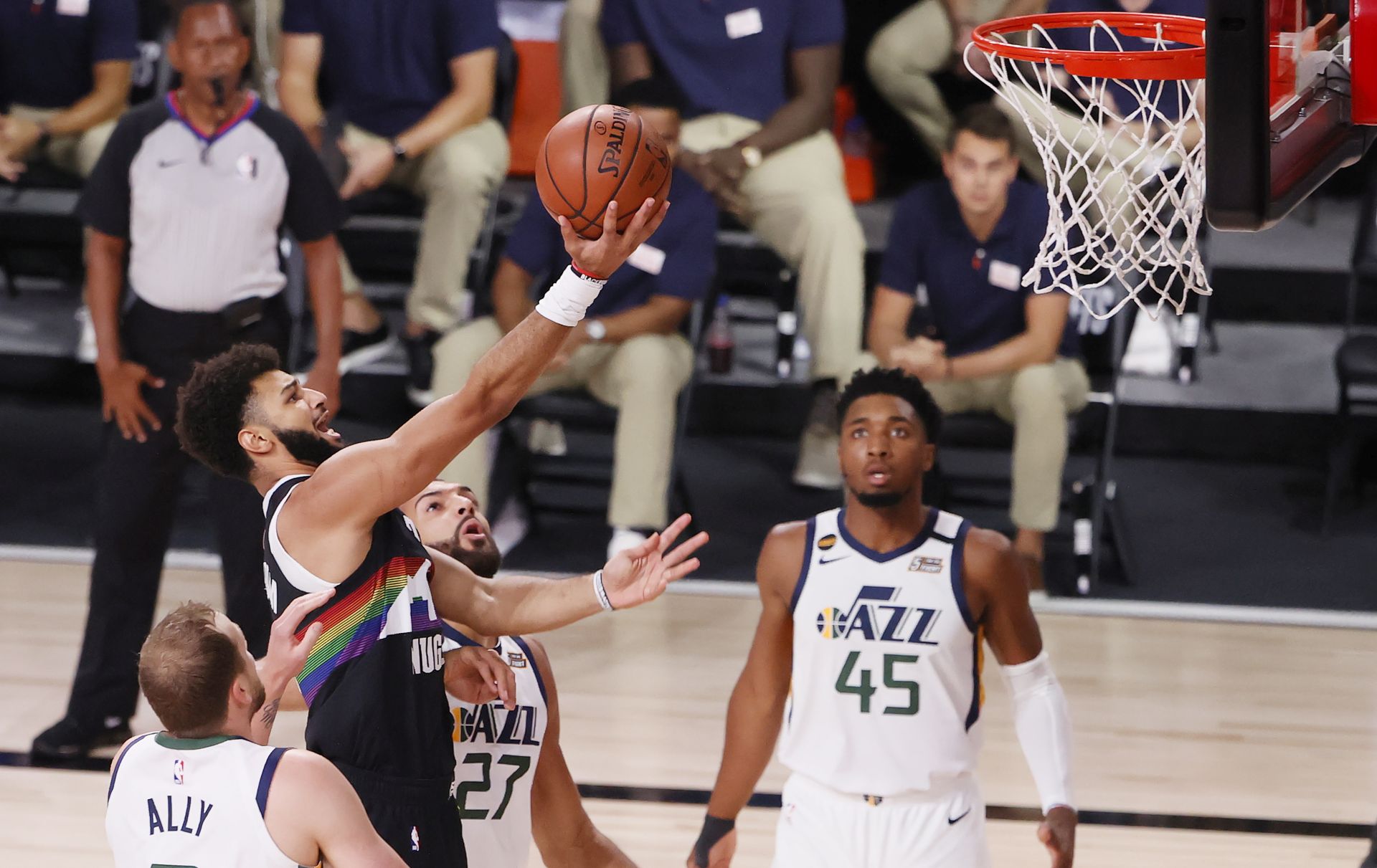 epa08640418 Denver Nuggets guard Jamal Murray (C) drives between Utah Jazz players (L-R) Joe Ingles, Rudy Gobert of France and Donovan Mitchell during the first half of the NBA basketball first round Western Conference playoff game seven between the Utah Jazz and the Denver Nuggets at the ESPN Wide World of Sports Complex in Kissimmee, Florida, USA, 01 September 2020.  EPA/ERIK S. LESSER SHUTTERSTOCK OUT