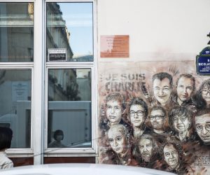 epa08640729 A woman looks at a paintings depicting Charlie Hebdo's killed cartoonists by French street artist Christian Guemy, outside the satirical 
newspaper Charlie Hebdo's former office, in Paris, France, 02 September 2020. The Charlie Hebdo terror attack trial will be held from 02 September to 10 November 2020. The Charlie Hebdo terrorist attacks in Paris happened on 07 January 2015, with the storming of armed Islamist extremists of the satirical newspaper, starting three days of terror in the French capital.  EPA/Mohammed Badra