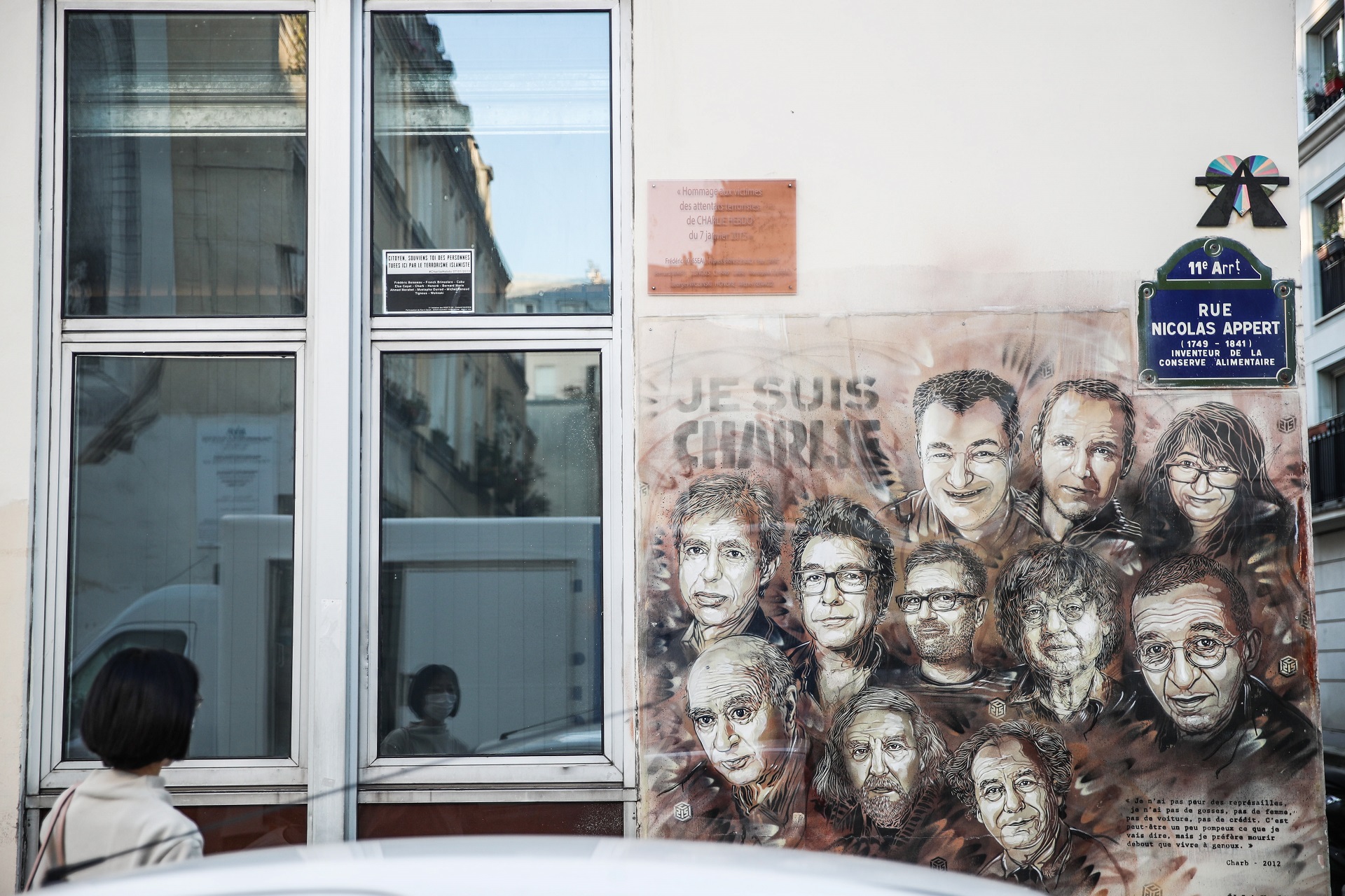 epa08640729 A woman looks at a paintings depicting Charlie Hebdo's killed cartoonists by French street artist Christian Guemy, outside the satirical 
newspaper Charlie Hebdo's former office, in Paris, France, 02 September 2020. The Charlie Hebdo terror attack trial will be held from 02 September to 10 November 2020. The Charlie Hebdo terrorist attacks in Paris happened on 07 January 2015, with the storming of armed Islamist extremists of the satirical newspaper, starting three days of terror in the French capital.  EPA/Mohammed Badra