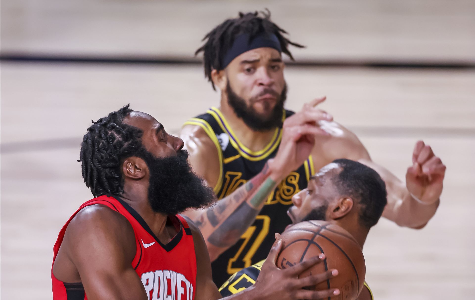 epa08651780 Houston Rockets guard James Harden (L) in action against Los Angeles Lakers center JaVale McGee (C) and Los Angeles Lakers forward LeBron James (R) during the first half of the NBA basketball semifinal Western Conference playoff game two between the Houston Rockets and the Los Angeles Lakers at the ESPN Wide World of Sports Complex in Kissimmee, Florida, USA, 06 September 2020.  EPA/ERIK S. LESSER  SHUTTERSTOCK OUT